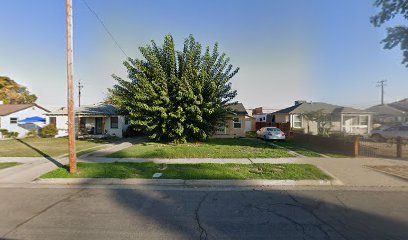 Fresno, CA home bought by Varo as-is: single-story home behind a large green shrub