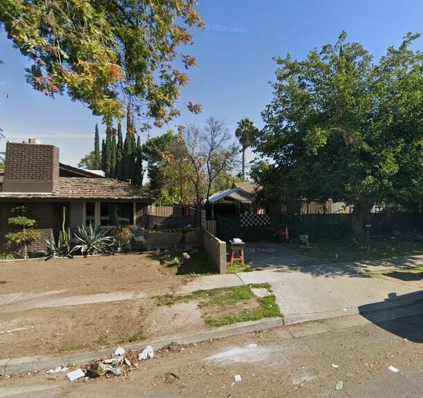 Fresno, CA home bought by Varo as-is: single-story brick home with a dirt front yard