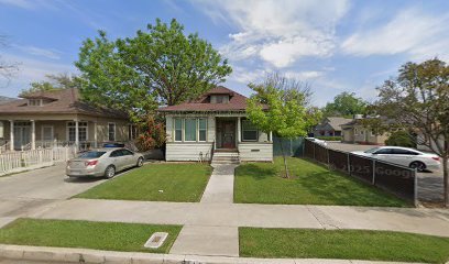 Hanford, CA home bought by Varo as-is: craftsman-style house with a green lawn and a car in the driveway