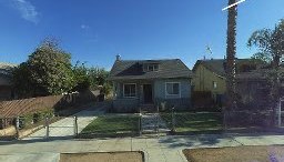 Fresno, CA home bought by Varo as-is: two-story blue-gray house with a fenced yard