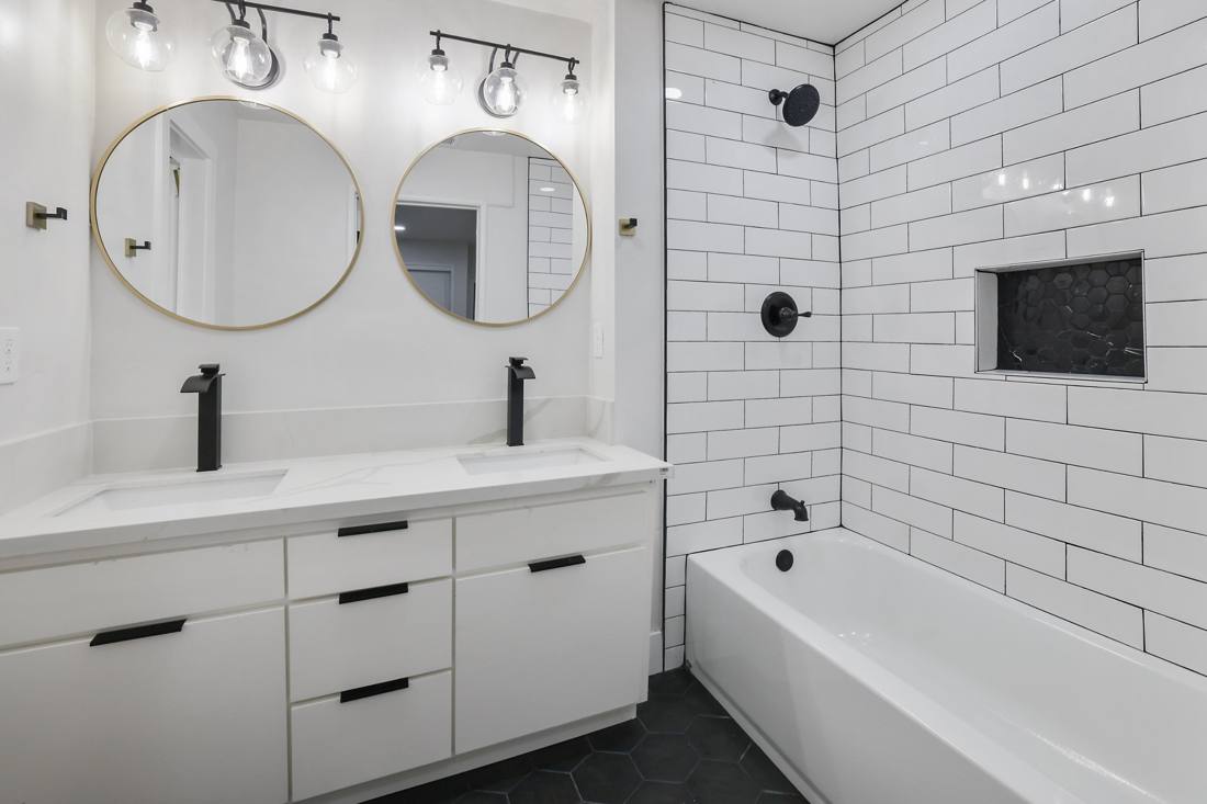 Bathroom: Subway tile, hex floor, brass mirrors